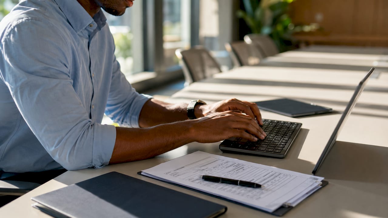 Hands typing eligibility verification RPA data